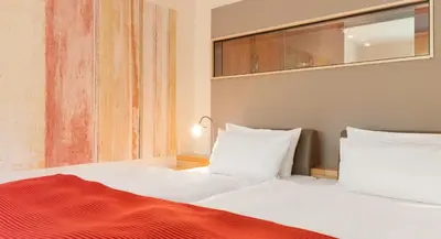Ein Bett oder Betten in einem Zimmer der Unterkunft A-ROSA Travemünde