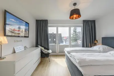 Ein Bett oder Betten in einem Zimmer der Unterkunft Fischerhuus Wohnung 3