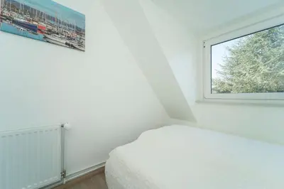 Ein Bett oder Betten in einem Zimmer der Unterkunft Ostseeferne