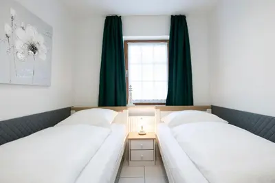 Ein Bett oder Betten in einem Zimmer der Unterkunft Alte Bergstraße 6 Schollenblick