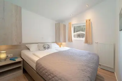 Ein Bett oder Betten in einem Zimmer der Unterkunft Ferienhäuser Lübecker Bucht Ferienhaus Strandläufer