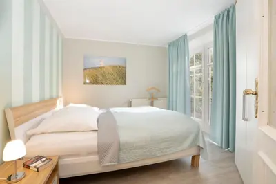 Ein Bett oder Betten in einem Zimmer der Unterkunft Haus Pegasus Küstenheimat