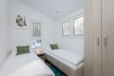 Ein Bett oder Betten in einem Zimmer der Unterkunft Ferienhäuser Lübecker Bucht Ferienhaus Beachcomber
