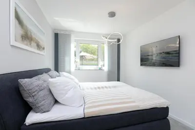 Ein Bett oder Betten in einem Zimmer der Unterkunft Passatstieg 1 Lüddn Traum