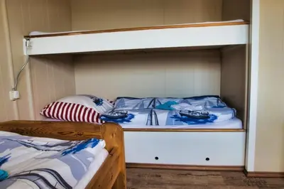 Ein Bett oder Betten in einem Zimmer der Unterkunft Finnenhaus 5