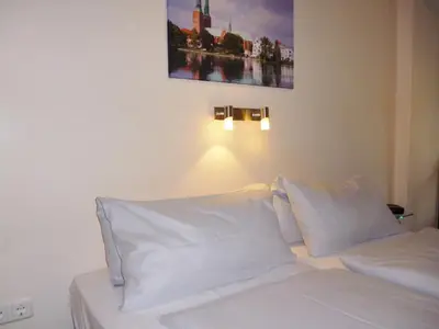 Ein Bett oder Betten in einem Zimmer der Unterkunft Hotel Am Mühlenteich