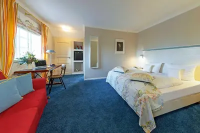 Ein Bett oder Betten in einem Zimmer der Unterkunft Romantik Hotel Friederikenhof Hotel Restaurant & Spa