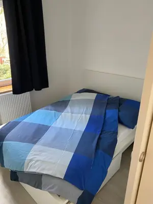 Ein Bett oder Betten in einem Zimmer der Unterkunft Zentrale und schöne Ferienwohnung