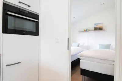 Ein Bett oder Betten in einem Zimmer der Unterkunft Ferienhäuser Lübecker Bucht Aquamarin