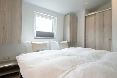 Ein Bett oder Betten in einem Zimmer der Unterkunft Ferienhäuser Lübecker Bucht Aquamarin