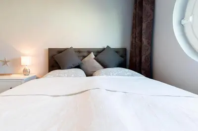 Ein Bett oder Betten in einem Zimmer der Unterkunft Exklusive Ferienwohnung Meerliebe