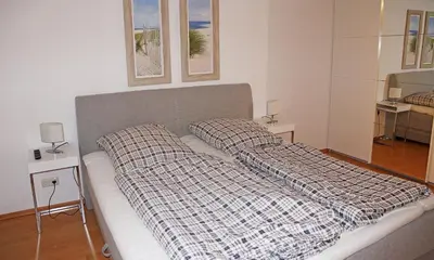 Ein Bett oder Betten in einem Zimmer der Unterkunft HansaResidenz Scharbeutz