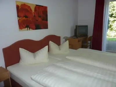 Ein Bett oder Betten in einem Zimmer der Unterkunft Hotel Grüner Jäger