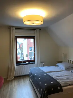 Ein Bett oder Betten in einem Zimmer der Unterkunft Möwenflug Apartments