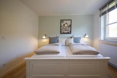 Ein Bett oder Betten in einem Zimmer der Unterkunft Cooles Ferienhaus HAFF COAST im Surfer-Style in Scharbeutz - Haffkrug