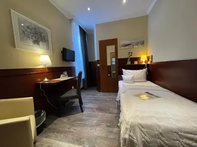 Ein Bett oder Betten in einem Zimmer der Unterkunft Hotel Hanseatic Lübeck