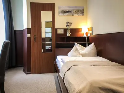Ein Bett oder Betten in einem Zimmer der Unterkunft Hotel Hanseatic Lübeck