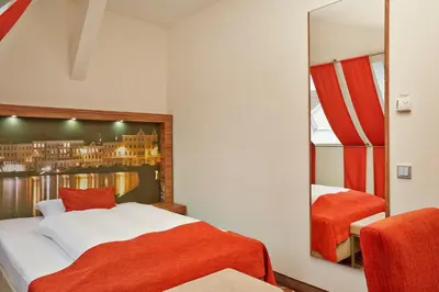 Ein Bett oder Betten in einem Zimmer der Unterkunft H+ Hotel Lübeck