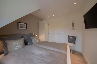 Ein Bett oder Betten in einem Zimmer der Unterkunft Ferienwohnung Neptuns Auszeit in Haffkrug