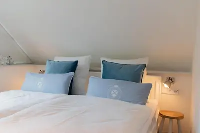 Ein Bett oder Betten in einem Zimmer der Unterkunft Ferienwohnung Neptuns Auszeit in Haffkrug