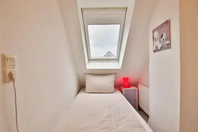 Ein Bett oder Betten in einem Zimmer der Unterkunft Timmendorfer Strand Haus Parkblick Appartement 10