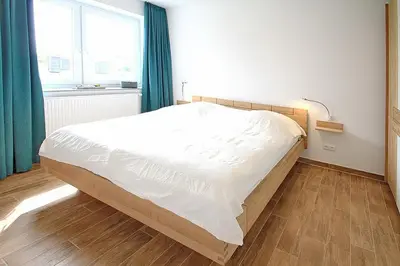 Ein Bett oder Betten in einem Zimmer der Unterkunft Die Wolburg Die Wolburg Appartement 6
