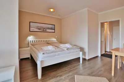 Ein Bett oder Betten in einem Zimmer der Unterkunft Residenz am Hang Residenz am Hang Appartement 411