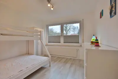 Ein Bett oder Betten in einem Zimmer der Unterkunft Ferienhaus Glockenstraße Ferienwohnung Ostseehöhe Appartement 1