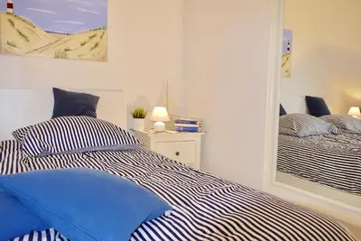 Ein Bett oder Betten in einem Zimmer der Unterkunft Strandduene Stranddüne Appartement 12