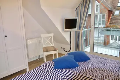 Ein Bett oder Betten in einem Zimmer der Unterkunft Strandduene Stranddüne Appartement 12