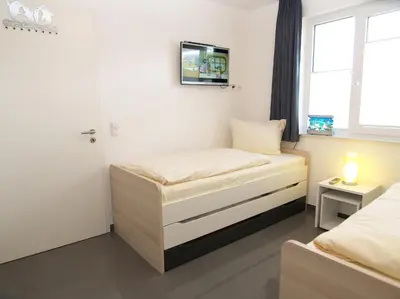 Ein Bett oder Betten in einem Zimmer der Unterkunft Strandglück Haus B Strandglück Appartement 12B