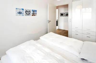 Ein Bett oder Betten in einem Zimmer der Unterkunft Strandglück Haus B Strandglück Appartement 8B