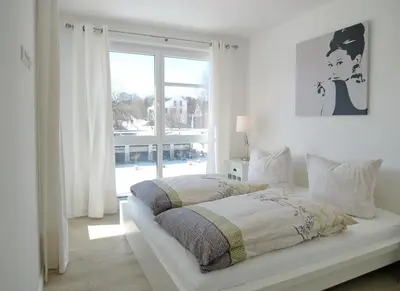 Ein Bett oder Betten in einem Zimmer der Unterkunft Strandglück Haus A Strandglück Appartement 7A