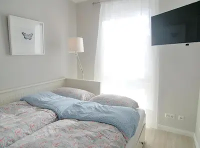 Ein Bett oder Betten in einem Zimmer der Unterkunft Strandglück Haus A Strandglück Appartement 7A