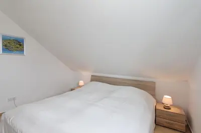 Ein Bett oder Betten in einem Zimmer der Unterkunft Feriendomizil am Konsulweg Feriendomizil am Konsulweg Appartement 7