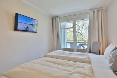 Ein Bett oder Betten in einem Zimmer der Unterkunft Strandglück Haus A Strandglück Appartement 14A