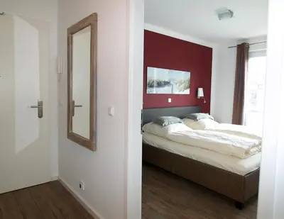 Ein Bett oder Betten in einem Zimmer der Unterkunft Strandglück Haus B Strandglück Appartement 15B