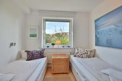 Ein Bett oder Betten in einem Zimmer der Unterkunft Strandschlößchen Strandschlösschen Appartement 1