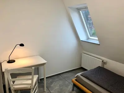 Ein Bett oder Betten in einem Zimmer der Unterkunft Dachgeschosswohnung mit Seeblick