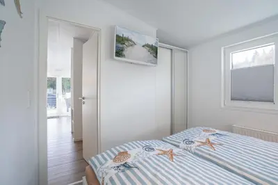 Ein Bett oder Betten in einem Zimmer der Unterkunft Ostseecamp Lübecker Bucht Haus Ankerplatz