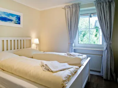 Ein Bett oder Betten in einem Zimmer der Unterkunft TRA7c Ferienwohnung Kossmann