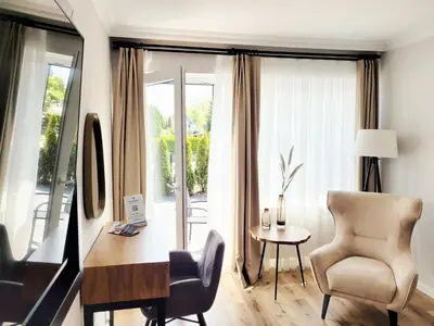 TV/Unterhaltungsangebot in der Unterkunft Hochwertige Ferienwohnung mit Sonnenterrasse & Gartenblick, nur wenige Gehminuten zum Strand