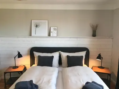 Ein Bett oder Betten in einem Zimmer der Unterkunft Alte Glaserei Travemünde