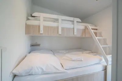 Ein Bett oder Betten in einem Zimmer der Unterkunft Ostseecamp Lübecker Bucht Ferienhaus 