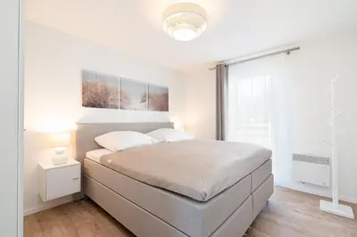 Ein Bett oder Betten in einem Zimmer der Unterkunft Strandpark Sierksdorf H024