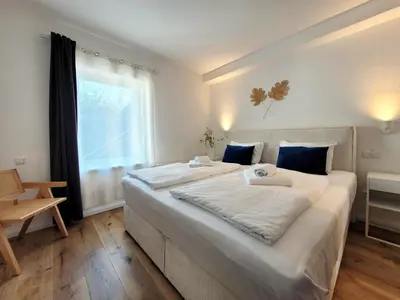 Ein Bett oder Betten in einem Zimmer der Unterkunft Ferienwohnung mit Meerblick und Terrasse - Nur 50 Meter zum Strand - inklusive eigenem Parkplatz und Fahrradunterstellplatz