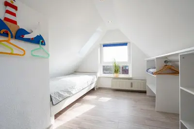 Ein Bett oder Betten in einem Zimmer der Unterkunft Strandwinkel