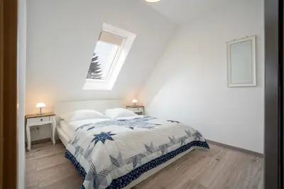 Ein Bett oder Betten in einem Zimmer der Unterkunft Strandwinkel
