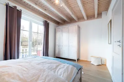 Ein Bett oder Betten in einem Zimmer der Unterkunft Iris Strandhus