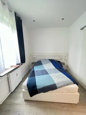 Ein Bett oder Betten in einem Zimmer der Unterkunft Zentrale und schöne Ferienwohnung II